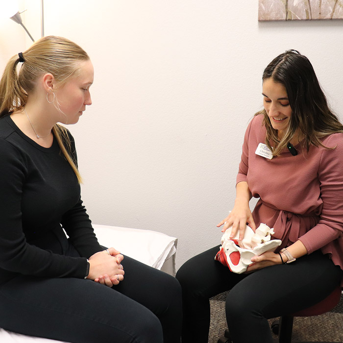physical therapist talking with client about pelvic health therapy
