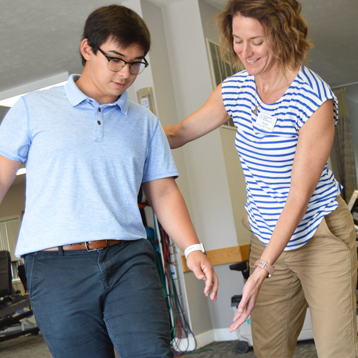 physical therapist doing leg exercises with patient